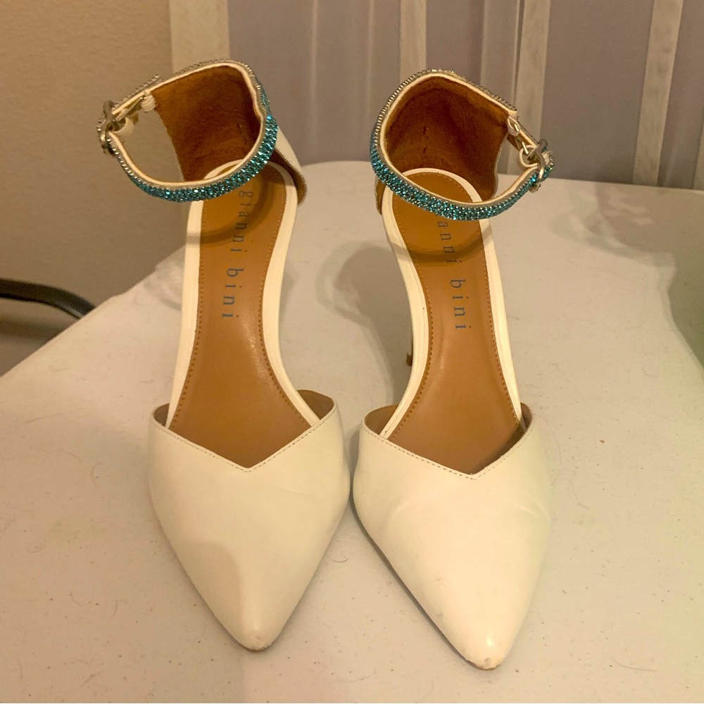 White closed toe heels with blue rhinestone ankle strap. Size 8.5.